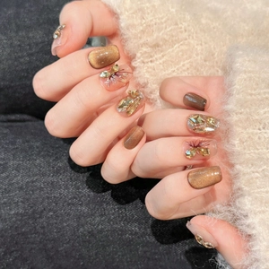 Golden brown cat-eye press-on nails with 3D diamond accents and floral hand-painted art