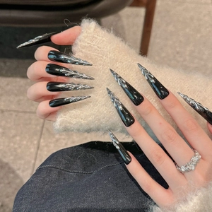 Gothic black press-on nails with 3D silver liquid metal flame patterns in stiletto shape