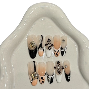 Handmade press-on nails with leopard patterns, 3D floral motifs, and crystal rhinestones