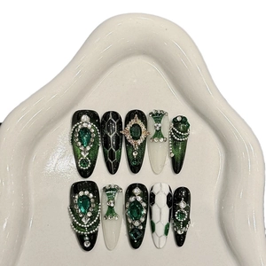 Handmade emerald green press-on nails with luxury rhinestones and football art
