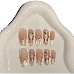Handmade cat eye press-on nails with pink gradient and gold firework patterns