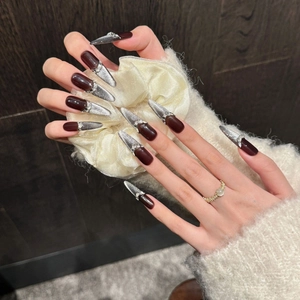 Handmade stiletto press-on nails in burgundy cat eye design with luxury rhinestones