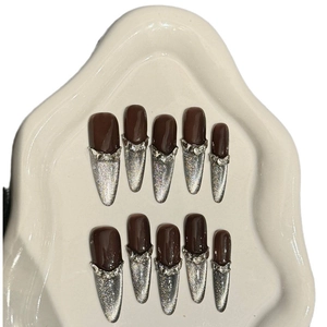Cat eye press-on nails with crown crystal accents on almond-shaped almond tips
