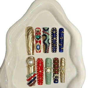 Luxurious handmade press-on nails with 3D metal textures and colorful gemstones