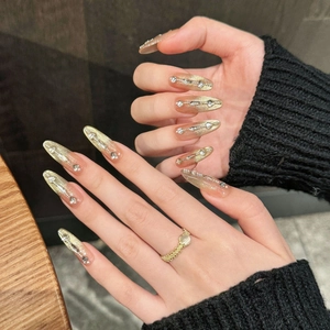 Golden cat-eye press-on nails with luxury rhinestones and silver metal line accents