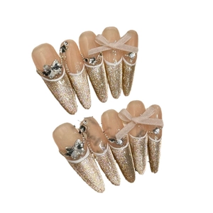 Handmade champagne gold glitter press-on nails with bow and rhinestone butterfly accents