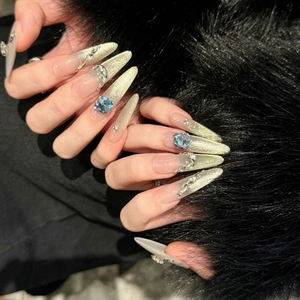 Extra long pointed cat eye press-on nails with luxury blue rhinestones and gold gradient