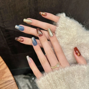Coffin press-on nails with blue-grey amber marble design and gold texture details