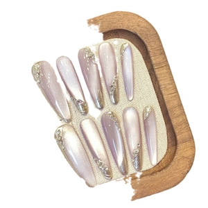 Purple cat-eye almond press-on nails with glitter foil and rhinestone accents