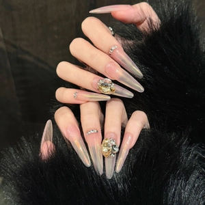 Pink aurora gradient press-on nails with luxury crystal rhinestones on black fur