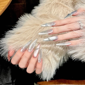 Long almond cat eye press-on nails with 3D floral accents and shimmering rhinestones