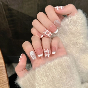 Pink French press-on nails with white plaid patterns and silver glitter for autumn style