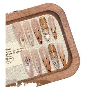 Handmade leopard heart stiletto press-on nails with chrome cross and 3D metallic accents