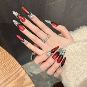 Red and black gradient cat-eye press-on nails with silver rhinestones on stiletto shape