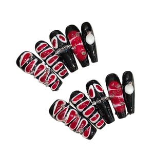 Dark gothic snake skin style press-on nails with red fluid patterns and metal rivets