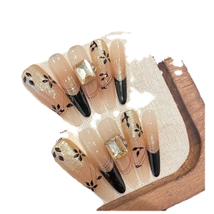 Handmade cat-eye press-on nails with champagne gold glitter and rectangle gems