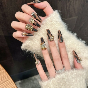 Matte leopard print press-on nails with amber rhinestones and long ballerina shape