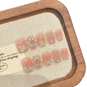 Handmade press-on nails with pink gradient, silver butterfly, pearls and rhinestones