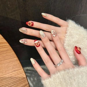 Faux ongles de Noël faits main avec renne rouge et motifs de boîte cadeau à nœud 3D