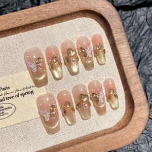 Handmade press-on nails set in champagne gold with 3D butterflies and glitter finish