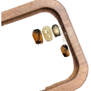 Maillard autumn amber press-on nails with marble texture and magnetic cat-eye effect