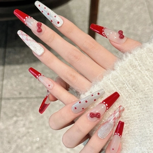 French red bow press-on nails with polka dots and marble patterns in long coffin shape
