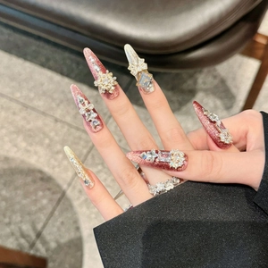 Handmade stiletto press-on nails with pink cat-eye glitter and 3D luxury rhinestones