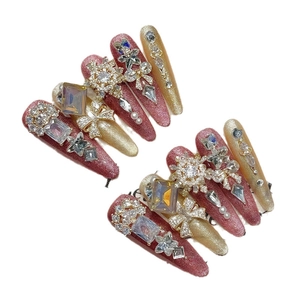 Luxurious handmade press-on nails with pink glitter, gold accents and zircon crystals