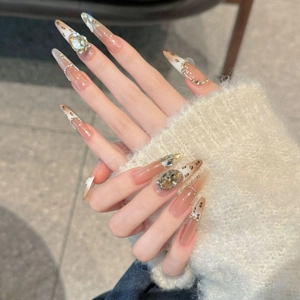 Long almond leopard print press-on nails with champagne rhinestones and glitter