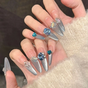 Blue rhinestone stiletto press-on nails with silver cat-eye gradient effect and pearls