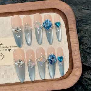 Blue cat eye press-on nails with heart rhinestones and gradient sparkling finish