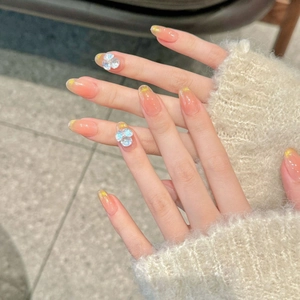 French style cat eye press-on nails with orange gradient, gold glitter, and 3D floral accents