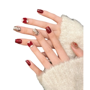 Red and gold handmade press-on nails with velvet bows and glitter for Lunar New Year