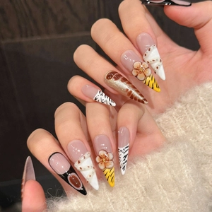 Handcrafted stiletto press-on nails featuring 3D floral art and amber animal prints
