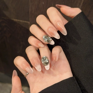 Cat eye blush gradient press-on nails with large oval rhinestones on index fingers
