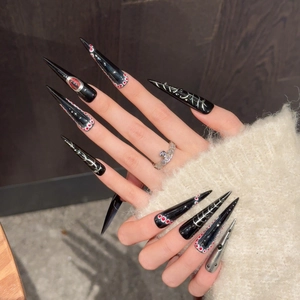 Gothic stiletto press-on nails with devil eye design and silver metallic accents