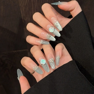 Unghie finte artigianali blu cat-eye con strass di lusso e decorazioni floreali