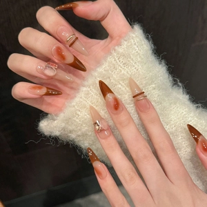 Brown amber gradient stiletto press-on nails with gold metal lines and 3D rhinestones