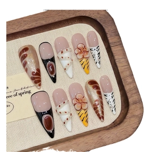 Handmade stiletto press-on nails with 3D floral carvings and amber textures