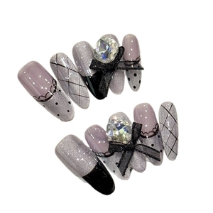 Purple cat eye press-on nails with 3D black mesh bows and luxury diamond accents