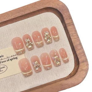 Faux ongles faits main œil de chat or rose champagne avec feuilles d'or et paillettes