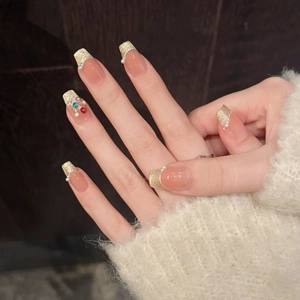 French style press-on nails with gold glitter tips, white pearls and colorful rhinestones