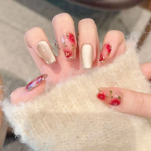 Handmade cat eye press-on nails with red cherry floral art on medium ballet shape
