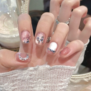 Pink cat eye press-on nails with 3D crystal butterflies and shimmering glitter accents