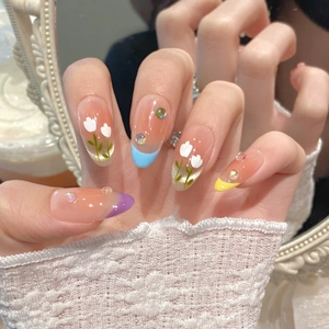 Hand-painted macaron tulip press-on nails with peach gradient and floral nail art design