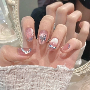 Pink cat-eye press-on nails with luxury butterfly sequins and rhinestone accents
