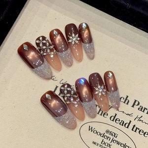 Cat eye press-on nails with brown gradient, glitter tips and luxury rhinestone accents