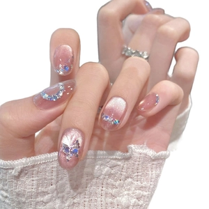 Pink cat eye press-on nails with butterfly sequins and sparkling glitter design