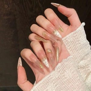 Elegant extra long stiletto press-on nails with marble cracks and pearl decoration