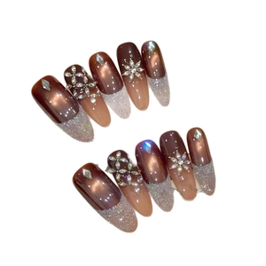 Brown cat eye press-on nails with luxury rhinestones and long almond shape design